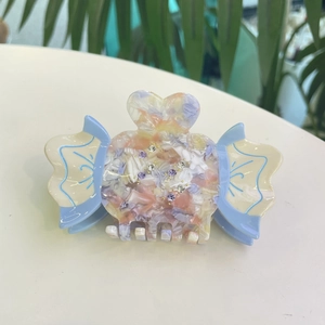 Colorful acetate hair claw clip with crystal details and marble candy pattern