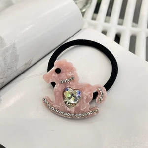 Pink resin rocking horse hair tie with a heart crystal and rhinestones for women