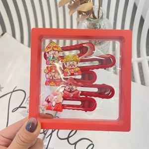 Close-up of five red New Year hair clips with folk deity motifs on a display stand