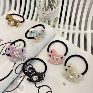 Detail of colorful resin rocking horse hair ties with heart crystals and rhinestones
