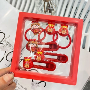 Festive Chinese New Year hair accessories set featuring red clips and ties in a gift box