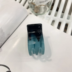 Detail of a high ponytail hair claw clip with black to lake blue gradient finish