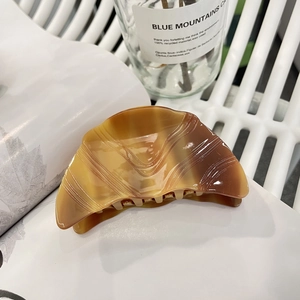 Coffee brown marble textured acetate hair claw clip with minimalist curved design and grooves