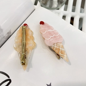 Close-up of marble texture ice cream hair clips with golden metal duckbill pins