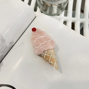 Cute pink ice cream cone hair clip made of acetic acid resin on a minimalist background
