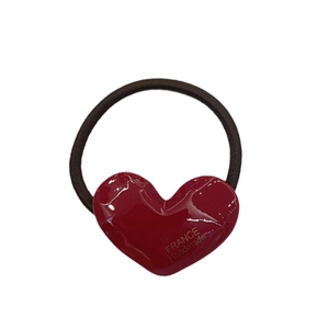 Red heart acetate hair clip with golden France Handmade label on white background