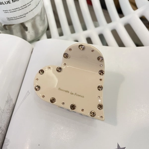 Pince à cheveux cœur en acétate beige avec strass et logo doré Barrette La France