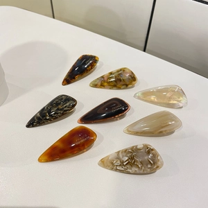 Close-up of acetate duckbill hair clips with marble and tortoiseshell patterns