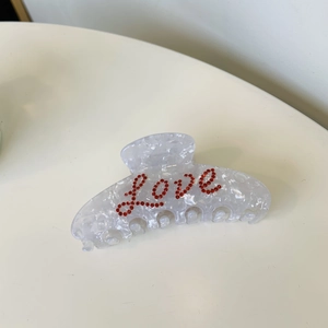 Elegante pinza per capelli bianco marmo con scritta LOVE in strass rossi da donna