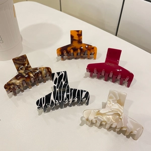 Detailed set of five acetate hair claws with marble and tortoise shell patterns