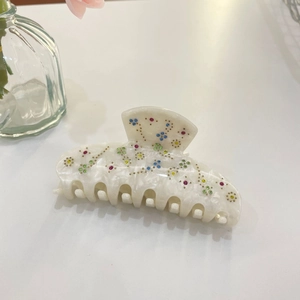 Elegant ivory acetate hair claw clip with colorful floral rhinestones and gold accents