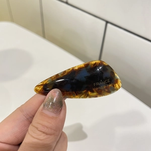Detailed close-up of tortoise shell pattern hair clip with France Handmade engraving