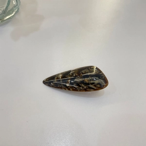 Macro detail of tortoiseshell hair clip showing the gold France Handmade engraving