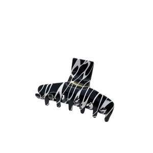 Elegant medium hair claw clip with black and white marble pattern in a glossy resin finish