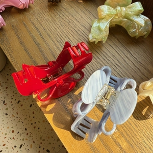 Close-up of acetic acid butterfly hair claws in marble red, blue, green and pink colors
