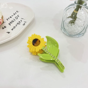 Sunflower acetate hair claw clip with rhinestones and green leaf design for women