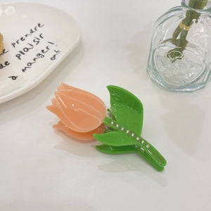 Elegant tulip-shaped acetate hair claw clip with pink petals and rhinestone green leaves