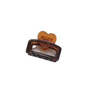 Chocolate brown acetate hair claw clip with amber heart handle on white background