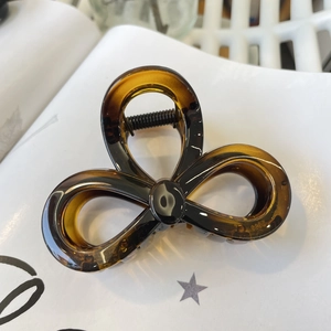 Detailed macro view of amber resin flower hair claw clip with S925 engraved mark