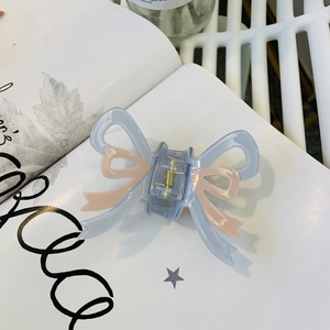 Elegant light blue acrylic bow hair claw clip with pink ribbons and golden spring for women