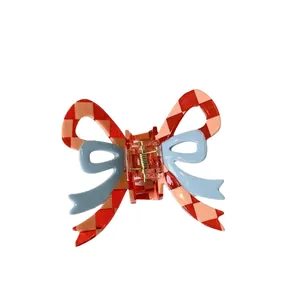 Sweet pink plaid bow hair claw clip with blue ribbon accent on white background