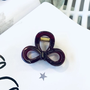 Detail view of deep purple translucent acrylic hair claw with three-ring hollow design