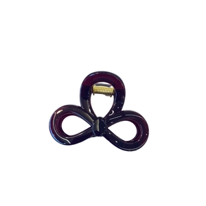Deep purple acrylic butterfly hair claw clip with golden metal spring on white background