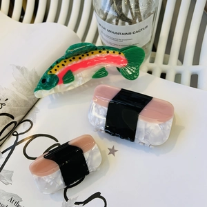 Creative acetate hair claws set featuring colorful rainbow trout and salmon sushi designs