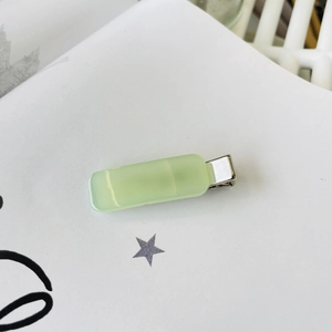 Detailed view of the mint green translucent acrylic hair clip with silver metal base