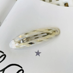 French vintage oval acetate hair clip in creamy white with natural sand texture