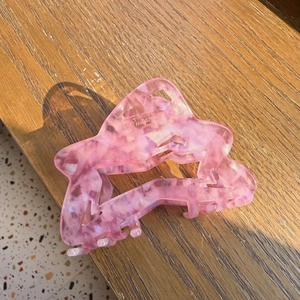 Pink marble acetate star hair claw clip with geometric pattern for women's hairstyle