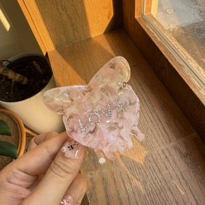 Elegant pink marble acetate butterfly hair claw clip with LOVE rhinestone embellishments