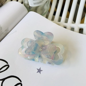 Blue and pink marbled resin butterfly hair claw clip with crystal on open book