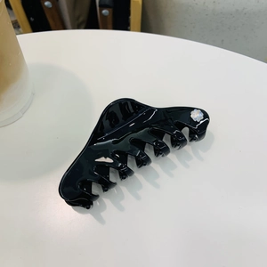 Elegant black glossy hair claw clip for women featuring a delicate floral rhinestone accent