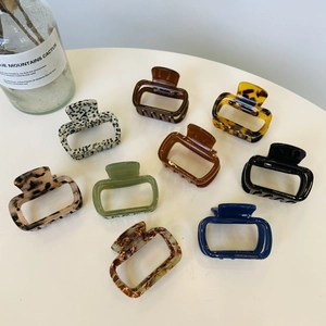 Detailed set of acetate hair claws in leopard, marble, and amber textures for women