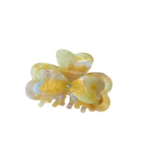 Elegant heart acetate hair claw with marble texture and sparkling rhinestone accent