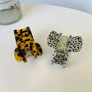 Detail of tortoise shell and spotted acetate hair claws with premium gold metal springs