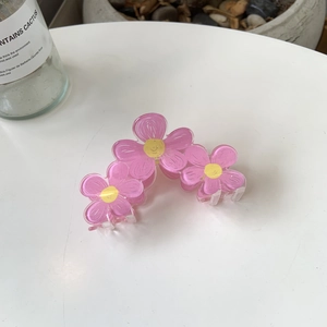 Pink acrylic flower hair claw clip with hand-painted daisy design for women styling