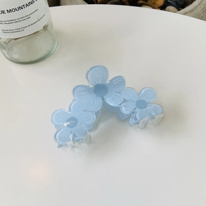 Blue acrylic flower hair claw clip with three translucent floral designs for women