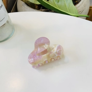 Pink and beige marble acetate claw clip with SANSHINE gold lettering for ponytail