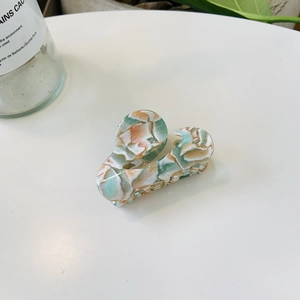 Elegant marble pattern acetate hair claw clip with green and orange tie-dye style design