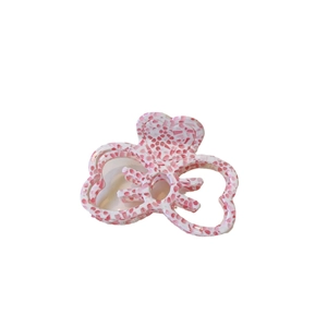 Pince à cheveux noeud marbré rose et blanc avec découpes en forme de cœur sur fond blanc