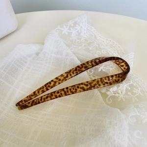 Detail of leopard print acetate U-shaped hair pin with Creation France engraving