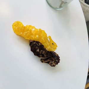 Seahorse hair claw clip with dual-color ocean design in yellow and brown acetate