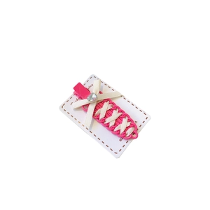 Pink bow hair clip with white ribbon and sparkling rhinestone on minimalist display card