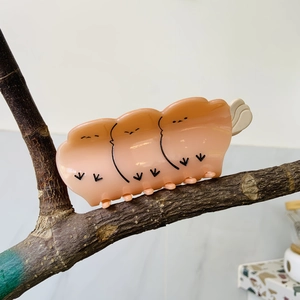 Cute pink long-tailed tit acetate hair claw clip featuring an original bird design