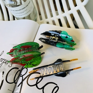 Detailed close-up of acetate Halloween hair claws featuring unique festive shapes and textures