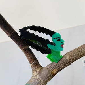 Acetate Halloween hair claw featuring Frankenstein's bride design on a tree branch
