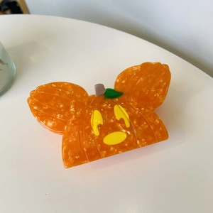 Detailed view of pumpkin-shaped hair claw made of orange acetate with glossy finish