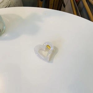 Pince à cheveux cœur évidé avec finition blanc nacré et ressort en métal doré